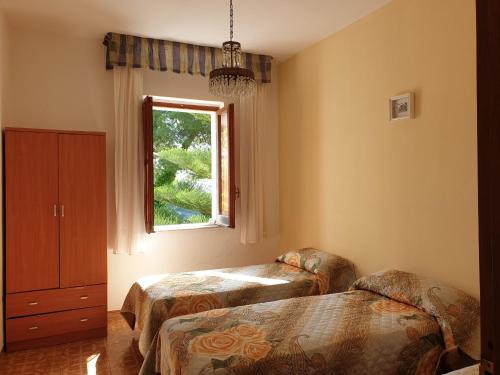 a room with two beds and a window at Casa Vacanze Fontanelle in Badolato