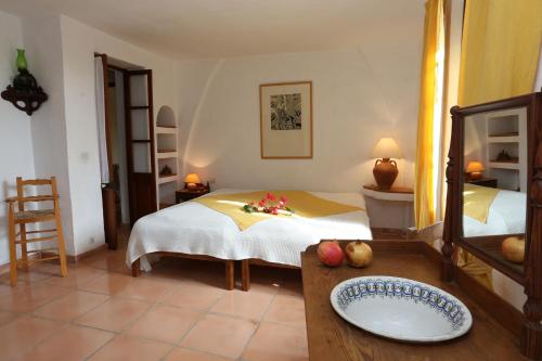 a bedroom with a bed and a table with a plate on it at Finca Sa Tafona in Son Servera