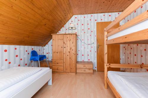 a bedroom with two bunk beds and a wooden ceiling at Haus Hafeneck mit Frühstücksoption in Bensersiel