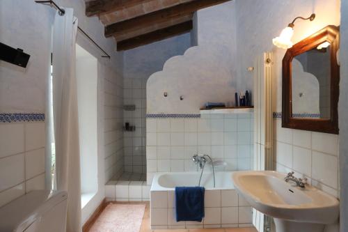 a bathroom with a bath tub and a sink at Finca Sa Tafona in Son Servera