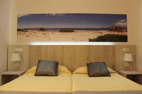 a bedroom with a bed and a painting on the wall at Venecia Apartments in Port d'Alcudia