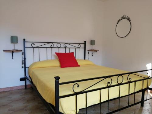 a bedroom with a bed with a red pillow on it at Sentieri sul Mare in Moneglia