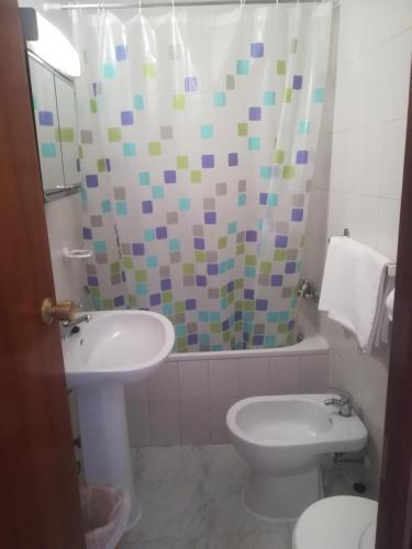a bathroom with a sink and a toilet and a shower at Pension La Linea in Puerto de Mazarrón