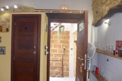 an open door in a kitchen with a brick wall at No3 CasaTosca Javea -Apart muy acogedor en el centro del Casco Antiguo in Jávea