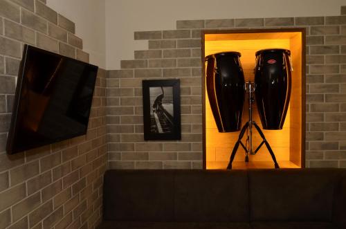 a room with a couch and a tv and a mirror at Music Hostel in Poltava