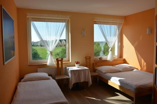 Postel nebo postele na pokoji v ubytování Słoneczny Dom pokoje i apartament na wynajem