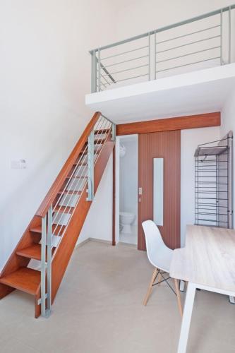 a staircase in a house with a table and a chair at Canggu Residence in Canggu