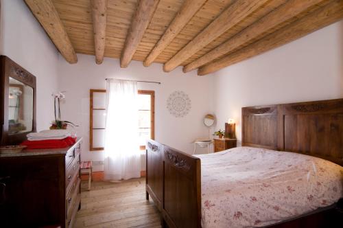 a bedroom with a large bed and a window at Le Fade in Susegana