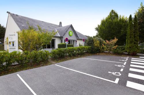 a parking lot in front of a house at Campanile Le Havre Nord - Montivilliers in Montivilliers