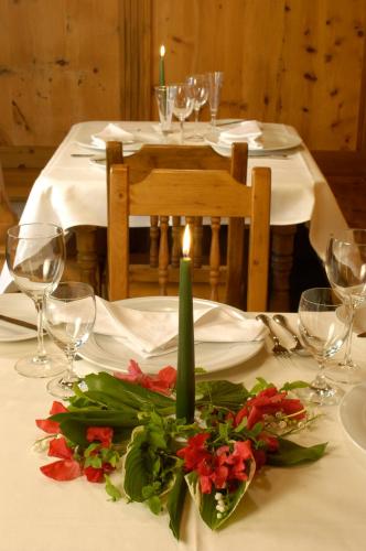 a table with a candle and flowers on a table at Golf- und Sporthotel Moarhof in Walchsee