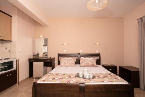 a bedroom with a large bed in a room at Dryades Apartments & Studios in Skala Potamias