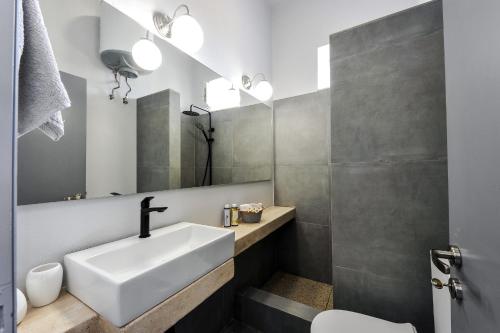 a bathroom with a sink and a mirror at Alia Studios in Gaios