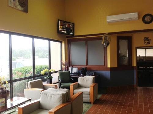 a waiting room with couches and chairs and windows at Days Inn by Wyndham Fayetteville-South/I-95 Exit 49 in Fayetteville