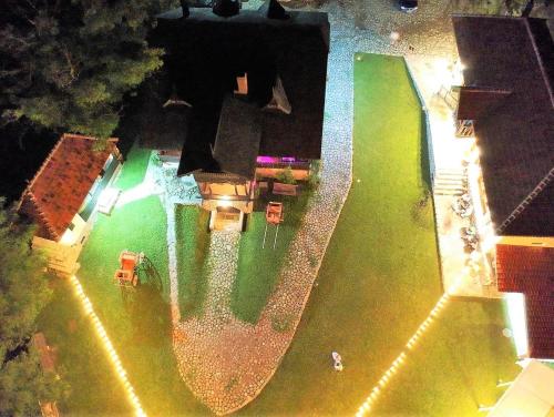 an overhead view of a swimming pool at night at Satul Banului Guesthouse in Măgureni