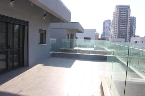 a balcony of a building with a view of a city at Desert Bird in Qiryat Gat