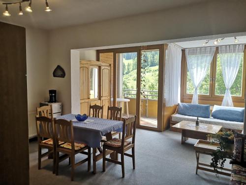 a living room with a table and chairs and a couch at Appartements Central in Bad Kleinkirchheim