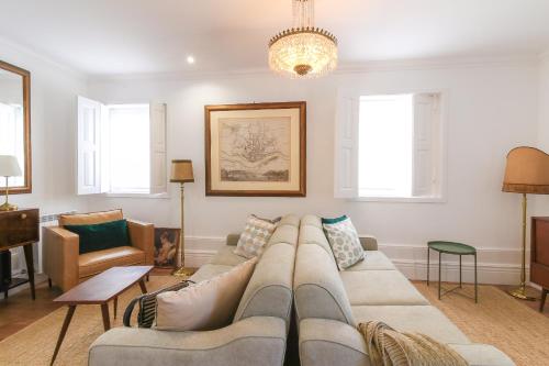 a living room with a couch and a chandelier at PORTO CONCEPT HOME - Paranhos in Porto