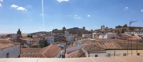 a view of a city with buildings and roofs at Apartamentos AL-QAZERES LUXURY La Concepción in Cáceres