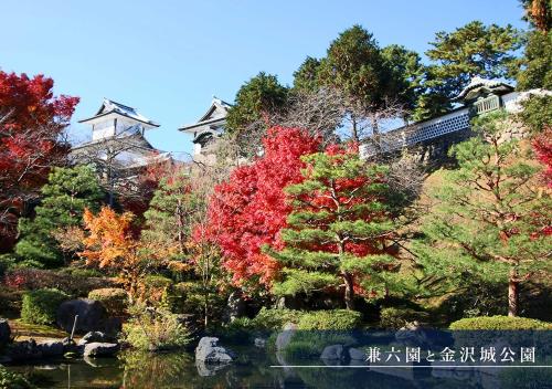 a garden with colorful trees and a pond at Arigato Stay Kanazawa Katamachi in Kanazawa