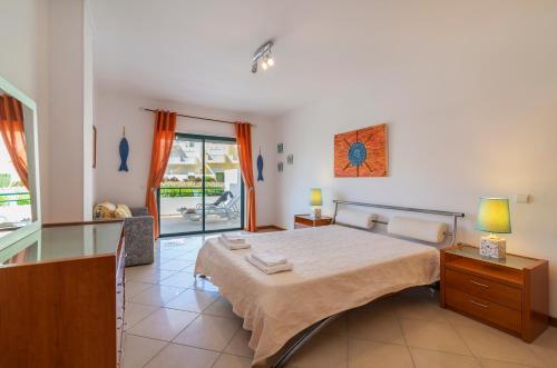 a bedroom with a large bed and a window at Condominio Jardins Santa Eulalia by Garvetur in Albufeira