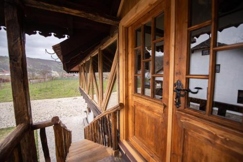 a wooden door of a house with a view of a field at Satul Banului Guesthouse in Măgureni