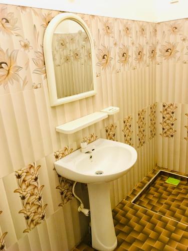 a bathroom with a sink and a mirror at Shashini Beach Resort in Arugam Bay