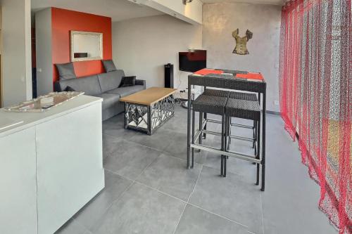a living room with a couch and a table at LE DONJON Villa BDSM Port Nature VILLAGE Cap d'Agde naturiste in Cap d'Agde