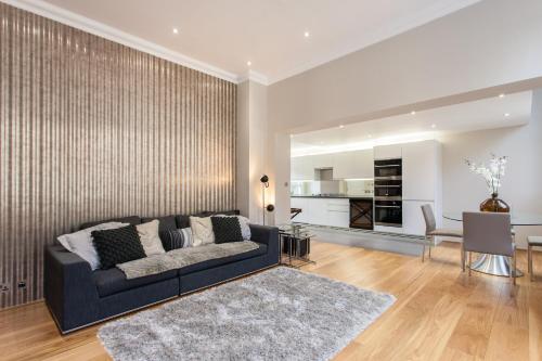 a living room with a couch and a dining room at The Harrington - Gloucester Road - 3 Harrington Gardens in London
