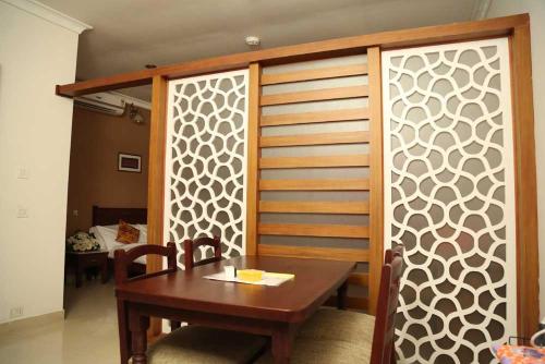 a dining room with a table and a wooden wall at Kallada hotels in Trichūr