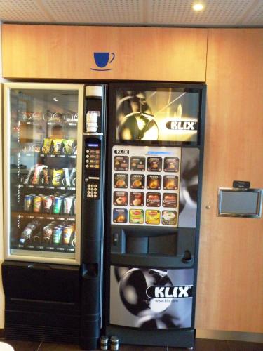 a vending machine with food and drinks in a room at ibis budget Montauban Les Chaumes in Montauban