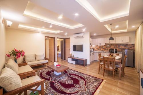 a living room with a couch and a table at Sarovar Residency Serviced Apartment Hotel in Jawlakhel