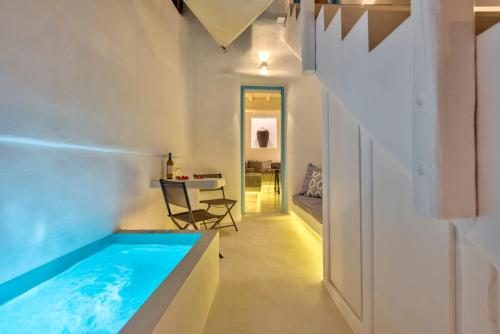 a house with a swimming pool in a room at Mykonian Mews Luxury Suites in Psarou