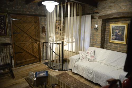 a living room with a white couch and a door at Crambero Suites in Alona