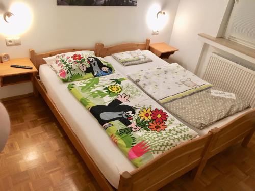 a bedroom with a bed with flowers on it at Ferienhaus Adele in Bad Neuenahr-Ahrweiler