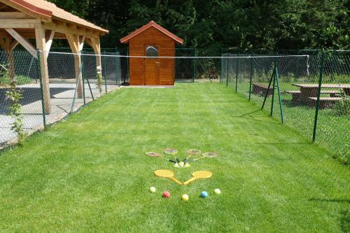 a fence with a bunch of eggs on the grass at Lednicko-valtický apartmán in Hlohovec