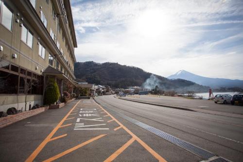 an empty street with a mountain in the background at Hotel Route-Inn Kawaguchiko in Fujikawaguchiko