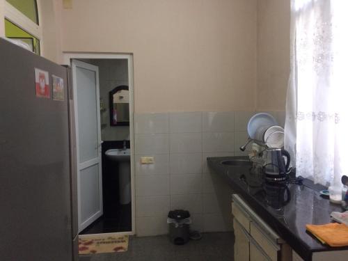 a kitchen with a counter and a sink and a mirror at Batumi Guesthouse 28a in Batumi