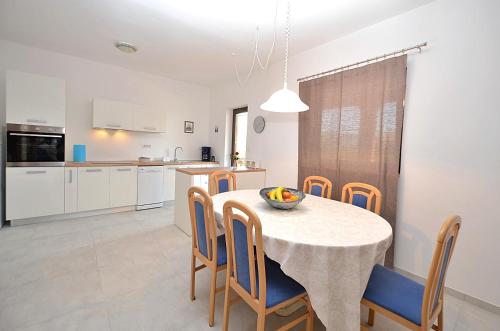 a kitchen and dining room with a table and chairs at Casa Sol Maris in Novigrad Istria