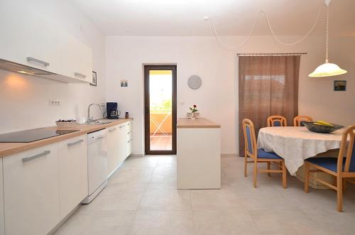 a kitchen with a table and a dining room at Casa Sol Maris in Novigrad Istria