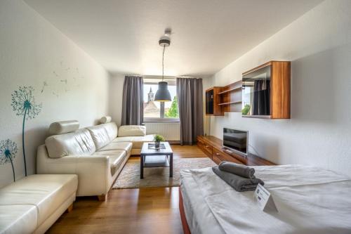 a living room with a couch and a table at SL'otel Budget in Bernburg