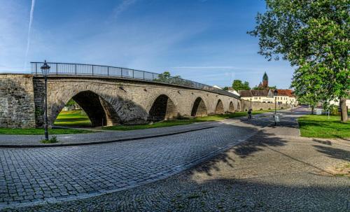 a stone bridge over a street with a road at SL'otel Budget in Bernburg