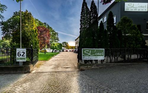 a street with a fence and a sign on it at SL'otel Budget in Bernburg