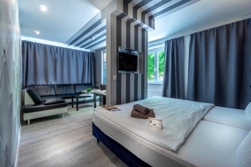 a bedroom with a bed and a tv in a room at SL'otel Budget in Bernburg