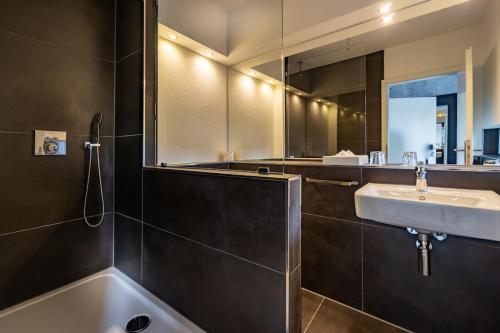 a bathroom with a sink and a mirror at SL'otel Budget in Bernburg