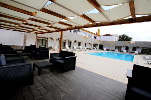 a patio with chairs and a swimming pool at Belo Horizonte in Luz