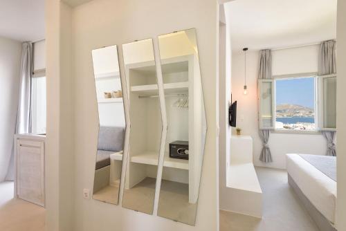 a dressing room with a mirror in a bedroom at Peven Suites in Naousa