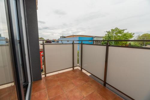 a balcony with a view of a building at Apartmány pri vstupe do Aquaparku in Senec