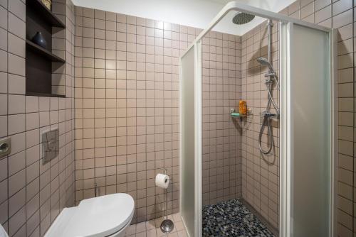 a bathroom with a shower with a toilet and a sink at Hotel Saida - quality hostel in Rīga