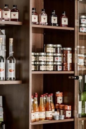 a shelf filled with lots of bottles of alcohol at Pension Gästehaus Heller in Weissenkirchen in der Wachau