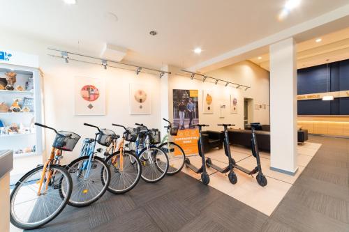 a row of bikes parked in a room at Park Hotel Latgola in Daugavpils